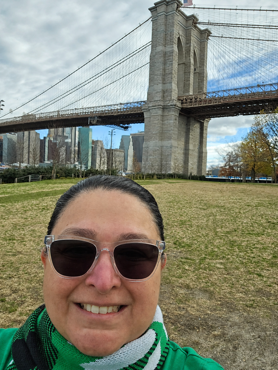 Michelle in front of the Brooklyn Bridge on a clear day